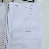 Calendar Day planner on a table with decorative items in the background